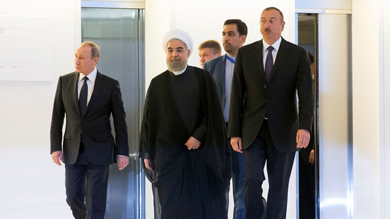 Russian President Vladimir Putin, Iranian President Hassan Rouhani and Azeri President Ilham Aliyev arrive for their meeting in Baku, Azerbaijan, August 8, 2016.  REUTERS/Alexander Zemlianichenko/Pool - RTSLUSE