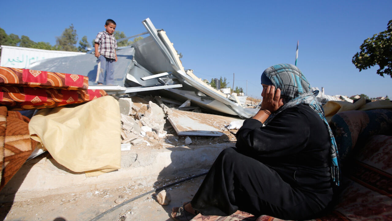 Palestinian woman reacts after Israeli troops demolished her shed near the West Bank village of Um AlKhair, south of Hebron A Palestinian woman reacts after Israeli troops demolished her shed near the West Bank village of Um AlKhair, south of Hebron August 9, 2016. REUTERS/Mussa Qawasma - RTSM063