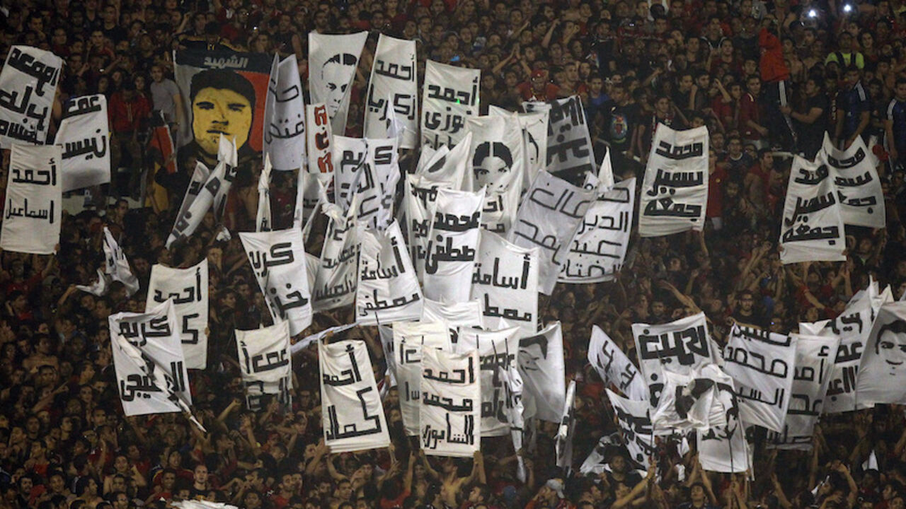 SOCCER-AFRICA/CHAMPIONS/ Fans of Egypt's Al-Ahli known as "Ultras" hold portraits with names of supporters who were killed in Port Said, during their African Champions League final soccer match against South Africa's Orlando Pirates at the Arab Contractors Stadium in Cairo November 10, 2013. Al Ahli's Mohamed Aboutrika underlined his status as the most successful player in African club competition over the last decade by scoring in a 2-0 final win over Orlando Pirates that clinched the African Champions League crown on Sunday. Port