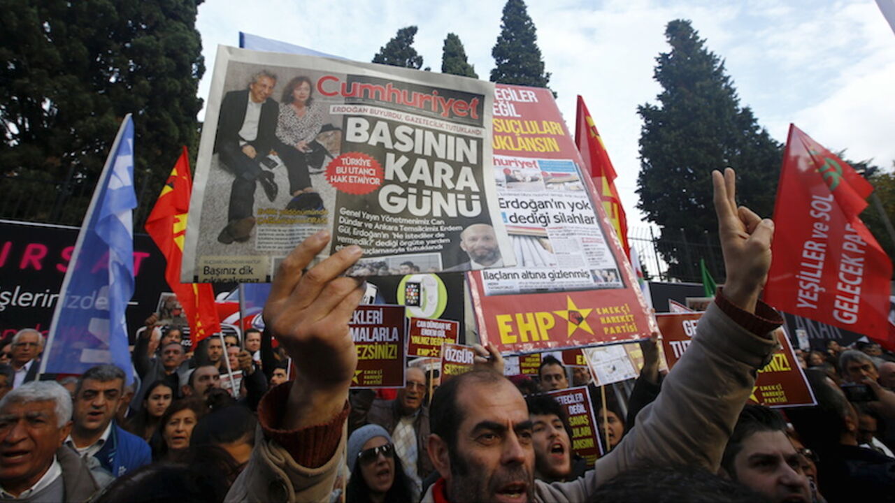 A demonstrator holds newspaper read "Black day of the press" during a protest outside the Cumhuriyet newspaper in Istanbul A demonstrator holds newspaper read "Black day of the press" during a protest outside the Cumhuriyet newspaper in Istanbul, Turkey, November 27, 2015. Around 2,000 people protested on Friday over the arrest of two prominent journalists on charges of espionage and terrorist propaganda, a case that has revived long-standing criticism of Turkey's record on press freedom under President Tayyip Erdogan. REUTERS/Osman Orsal - RTX1W3XS