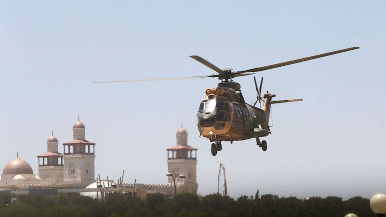 A military helicopter transports a security member, who was injured during an attack at a camp for Syrian refugees in eastern Jordan near the borders of Iraq, Syria and Jordan, to al-Hussein Medical Centre in Amman, Jordan, June 21, 2016.  REUTERS/Stringer - RTX2HCNT