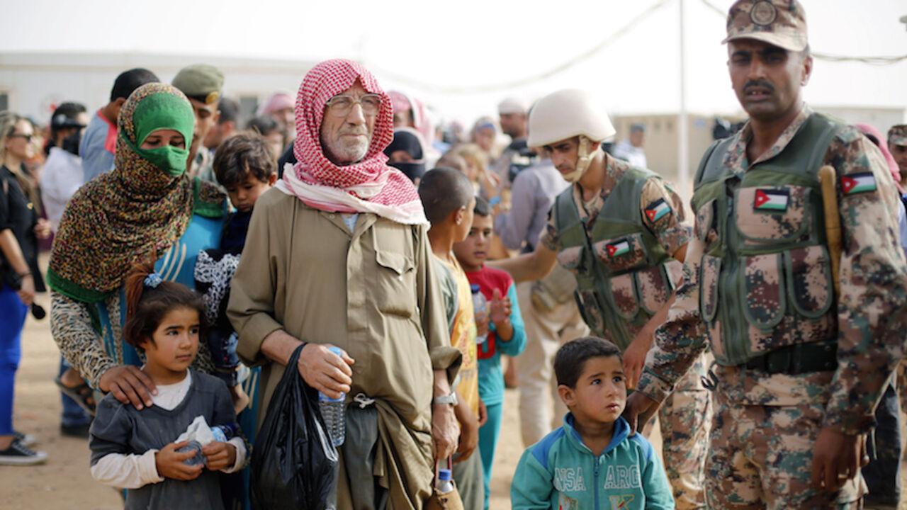 Syrian refugees wait to board a Jordanian army vehicle after crossing into Jordanian territory Syrian refugees wait to board a Jordanian army vehicle after crossing into Jordanian territory with their families, in Al Ruqban border area, near the northeastern Jordanian border with Syria, and Iraq, near the town of Ruwaished, 240 km (149 miles) east of Amman September 10, 2015. Picture taken September 10, 2015. REUTERS/Muhammad Hamed - RTX2II4S