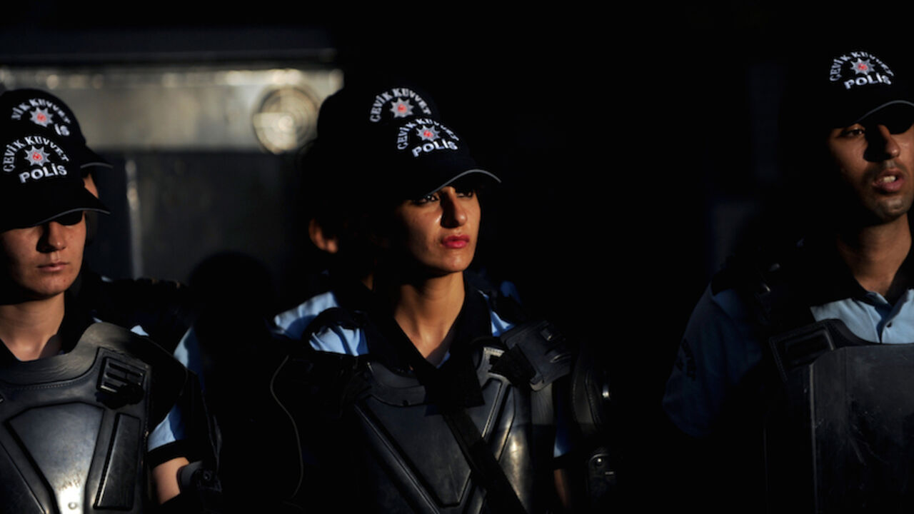 Turkish riot police stand guard as Kurdi Turkish riot police stand guard as Kurdish women (unseen) sit during a protest in downtown Istanbul, on August 29, 2011. The group of Kurdish women gathered to protest Turkish military air strikes against Kurdish separatists in northern Iraq. Meanwhile, Turkish jets bombed bases in northern Iraq used by the separatist Kurdistan Workers' Party (PKK) in a fresh campaign which has killed as many as 160 rebels since last week, the military said on August 29. AFP PHOTO / BULENT KILIC (Photo credit should read BU