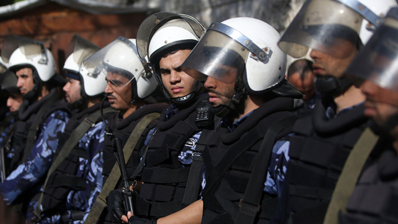 Nic6401737 Hamas security forces stand guard at the entrance of the cabinet headquarters of Gaza's Hamas rulers on December 30, 2014 in Gaza City before a meeting of Palestinian unity government officials to launch reconstruction of the territory devastated by a 50-day summer war with Israel. Speaking late on December 29 shortly after a ministerial delegation from the West Bank arrived in Gaza, former Hamas prime minister Ismail Haniya accused the government of failing "to keep its commitments, by not carrying out rec