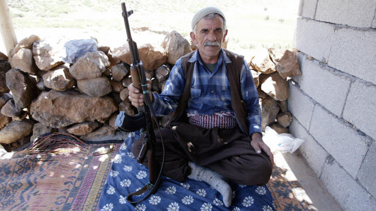 Par251856 Siirt, TURKEY: A village guard poses with his rifle in his cabin in the mountainous southeastern city of Siirt, Pervari province, 28 June 2005. The outlawed Kurdistan Worker's Party (PKK) retaliated by blowing up a train in Bingol at the weekend, killing five people. The unrest marks sharply increased violence between the PKK and the army in the Turkish southeast since April, months after the rebels, 01 June 2004, called off a five-year unilateral ceasefire. AFP PHOTO/MUSTAFA OZER (Photo credit sh