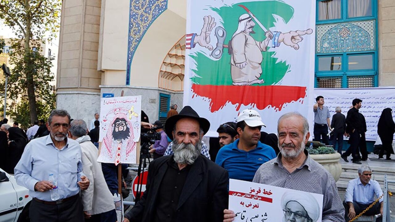 AFP_G01LR Iranian men holding a picture Bahraini Shiite cleric Sheikh Isa Qassim (R) and a caricature of the Saudi king, participate in an anti-Saudi demonstration in the capital Tehran on September 9, 2016.
With Iranians barred from the annual hajj pilgrimage, thousands protested in Tehran and officials criticised Saudi Arabia's refusal to discuss last year's deadly stampede during which more than 400 Iranians were among the nearly 2,300 pilgrims that were killed. The writing on the posters in Arabic read "Malicious