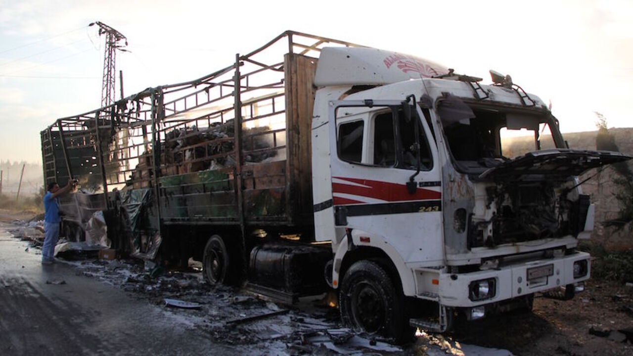 AFP_GB429 A damaged truck carrying aid is seen on the side of the road in the town of Orum al-Kubra on the western outskirts of the northern Syrian city of Aleppo on September 20, 2016, the morning after a convoy delivering aid was hit by a deadly air strike.
The UN said at least 18 trucks in the 31-vehicle convoy were destroyed en route to deliver humanitarian assistance to the hard-to-reach town.
/ AFP / Omar haj kadour (Photo credit should read OMAR HAJ KADOUR/AFP/Getty Images)