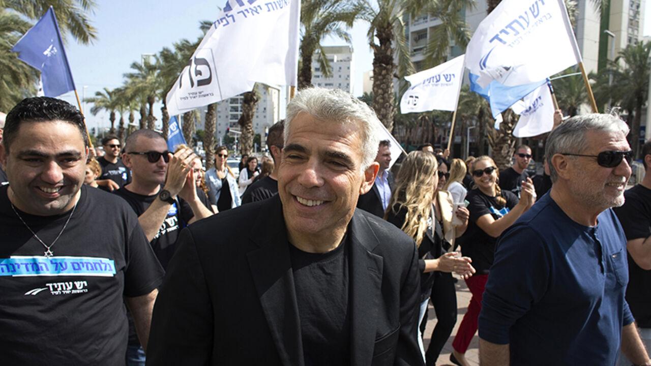 ISRAEL-ELECTION/LAPID Yesh Atid leader Yair Lapid (C) walks with supporters as he campaigns in the southern city of Ashdod March 15, 2015. The era of Prime Minister Benjamin Netanyahu is ending, with Israeli voters clearly more concerned about economic and social issues than about security or fears over Iran, Lapid said on Monday. Lapid, a telegenic former news anchor and TV host, leads the centrist, secular Yesh Atid party ("There's a Future"), which emerged out of the cost-of-living protests that swept Israel in 2011. Picture