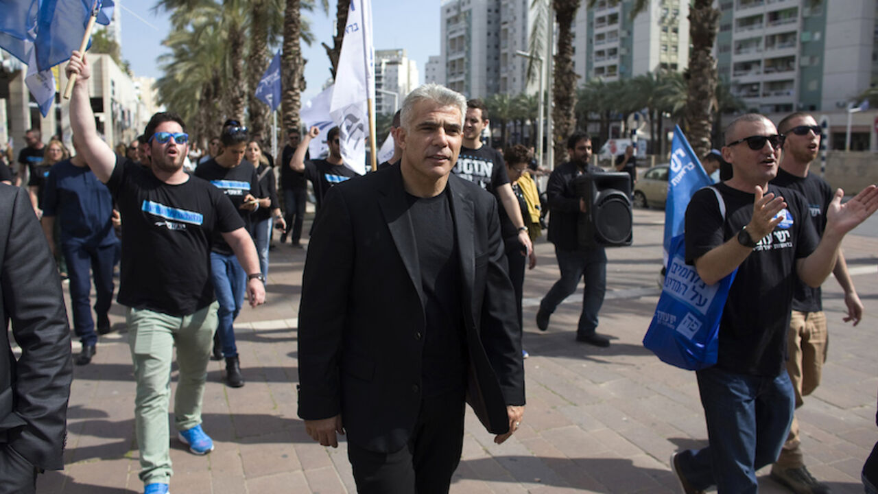 Yesh Atid leader Yair Lapid walks with supporters as he campaigns in the southern city of Ashdod Yesh Atid leader Yair Lapid (C) walks with supporters as he campaigns in the southern city of Ashdod March 15, 2015. The era of Prime Minister Benjamin Netanyahu is ending, with Israeli voters clearly more concerned about economic and social issues than about security or fears over Iran, Lapid said on Monday. Lapid, a telegenic former news anchor and TV host, leads the centrist, secular Yesh Atid party ("There's a Future"), which emerged out of the cost-of-living protests that swept Israel in 2011. Picture