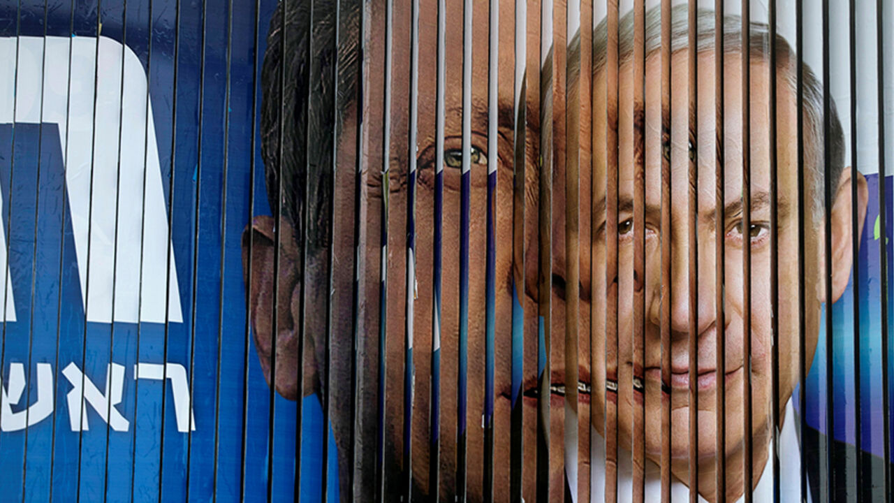 ISRAEL-GOVERNMENT/ Israel's Prime Minister Benjamin Netanyahu (R) and Isaac Herzog, co-leader of the Zionist Union party, are pictured together as campaign billboards rotate in Tel Aviv, March 9, 2015. REUTERS/Baz Ratner/File Photo - RTSEUAF