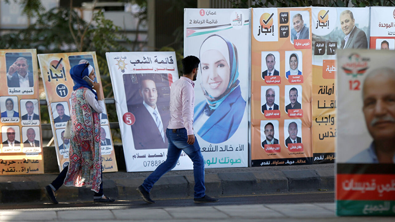 JORDAN-ELECTION/ People walk past electoral posters for parliamentary candidates, ahead of the general elections to be held on September 20, in Amman, Jordan, September 16, 2016. REUTERS/Muhammad Hamed - RTSO224