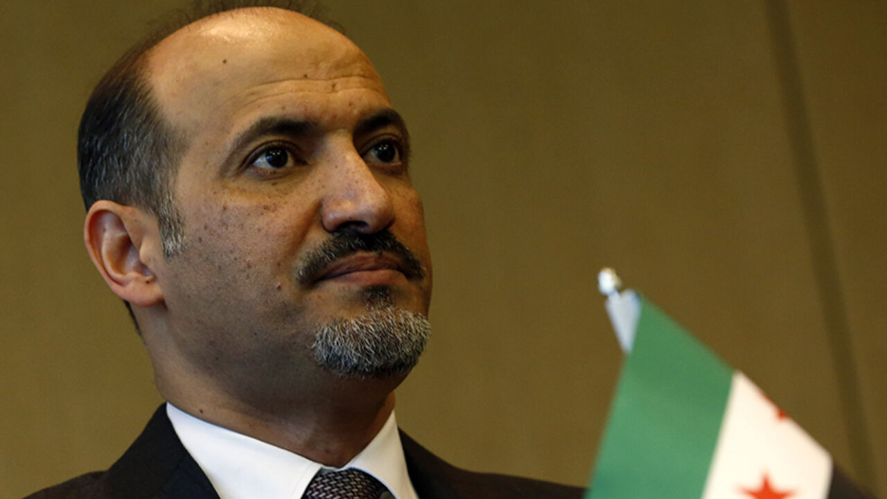 Syrian opposition leader Ahmad Jarba looks on as he makes a statement after the conclusion of talks on Syria, in Geneva January 31, 2014.   REUTERS/Denis Balibouse (SWITZERLAND - Tags: POLITICS) - RTX182HC