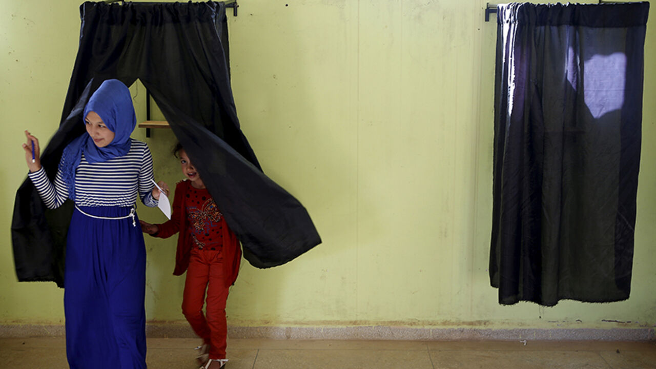 MOROCCO-ELECTION/ A woman (L) leaves a booth before casting her ballot at a polling station in the town of Tifelt, east of Rabat, Morocco September 4, 2015. Morocco's ruling Islamist party on Friday faced a major test of its dominance as polls opened for local elections for which most opposition parties have campaigned on anti-corruption platforms and against privileges for the elite. REUTERS/Youssef Boudlal TPX IMAGES OF THE DAY - RTX1R65C