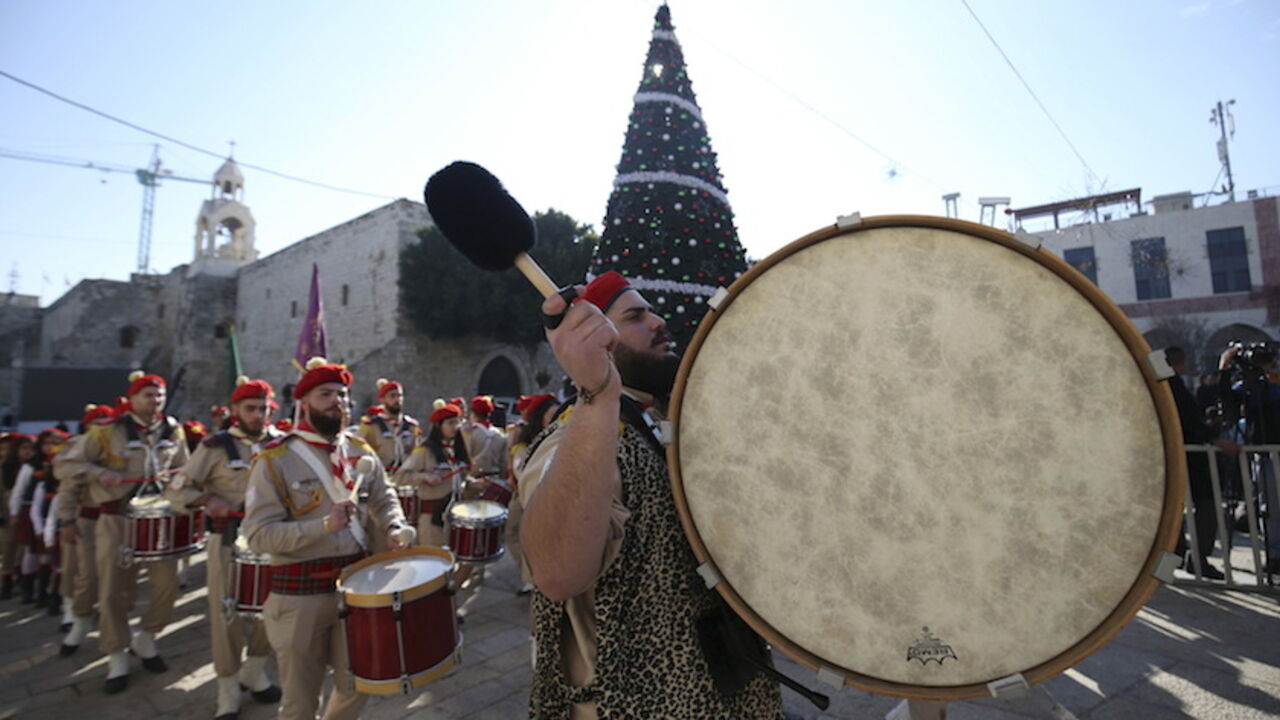 A Palestinian marching band parades during a Christmas procession at Manger Square in Bethlehem A Palestinian marching band parades during a Christmas procession at Manger Square in the West Bank town of Bethlehem December 24, 2015. REUTERS/Mohamad Torokman - RTX1ZYV3