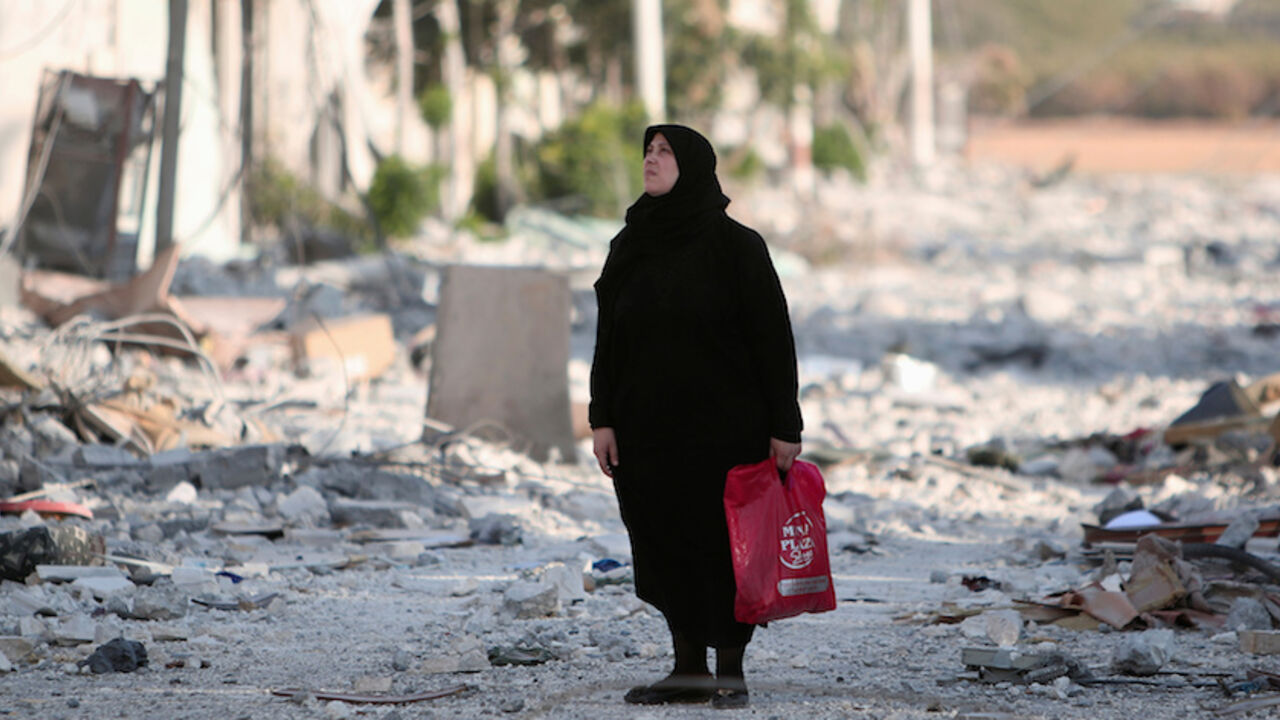 A woman stands along a damaged street in Manbij, Aleppo Governorate A woman stands along a damaged street in Manbij, Aleppo Governorate, Syria, August 16, 2016. REUTERS/Rodi Said - RTX2LBQT