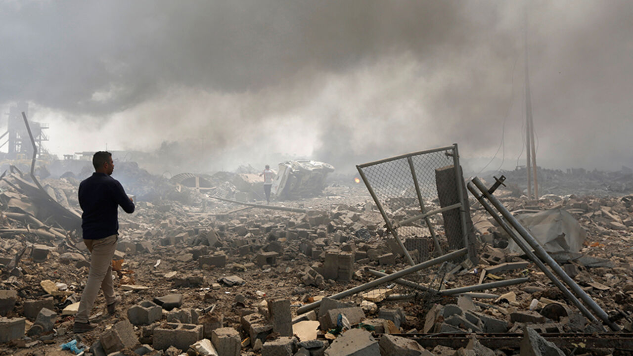 MIDEAST-CRISIS/IRAQ-BLAST A man walks at a destroyed building at the site of a blast caused by a fire at a weapons storage in eastern Baghdad, Iraq, September 2, 2016. REUTERS/Ahmed Saad - RTX2NV19
