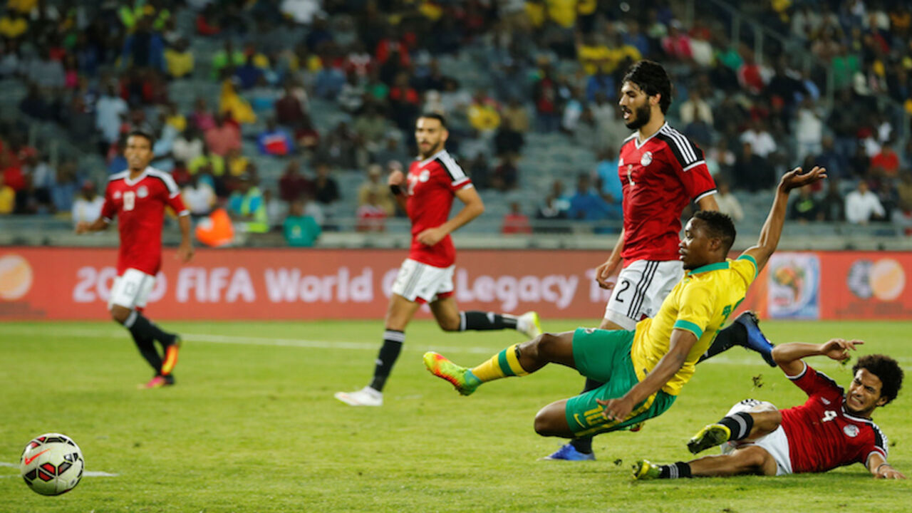 Football Soccer - South Africa v Egypt - Nelson Mandela Challenge soccer match - Orlando Stadium, Soweto, South Africa Football Soccer - South Africa v Egypt - Nelson Mandela Challenge soccer match - Orlando Stadium, Soweto, South Africa - 6/9/16 South Africa's Sibusiso Vilakazi (L) is tackled by Egypt's Omar Gaber. REUTERS/Siphiwe Sibeko - RTX2OEK5