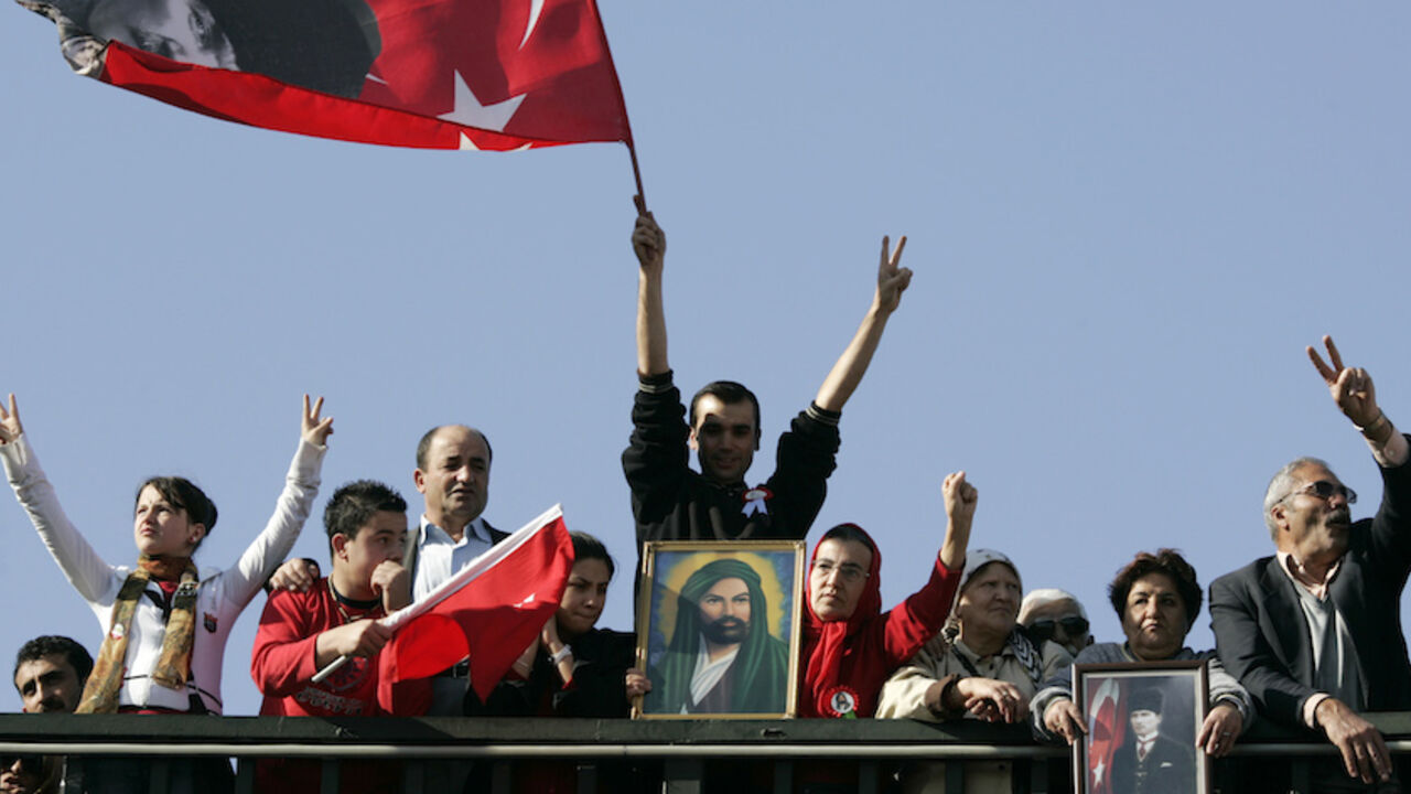 Turkish Alevis make v-signs, hold national flags and portraits of Mustafa Kemal Ataturk and Hadrat Ali Ibn Abu Talib during a rally in Ankara Turkish Alevis make v-signs, hold national flags and portraits of Mustafa Kemal Ataturk and Hadrat Ali Ibn Abu Talib, son-in-law of Prophet Mohammed, during a rally in Ankara November 9, 2008. Thousands of Turkish Alevis marched in Ankara on Sunday in their first massive demonstration to call for an end to discrimination by the government and compulsory religious classes. REUTERS/Umit Bektas (TURKEY) - RTXAF2X