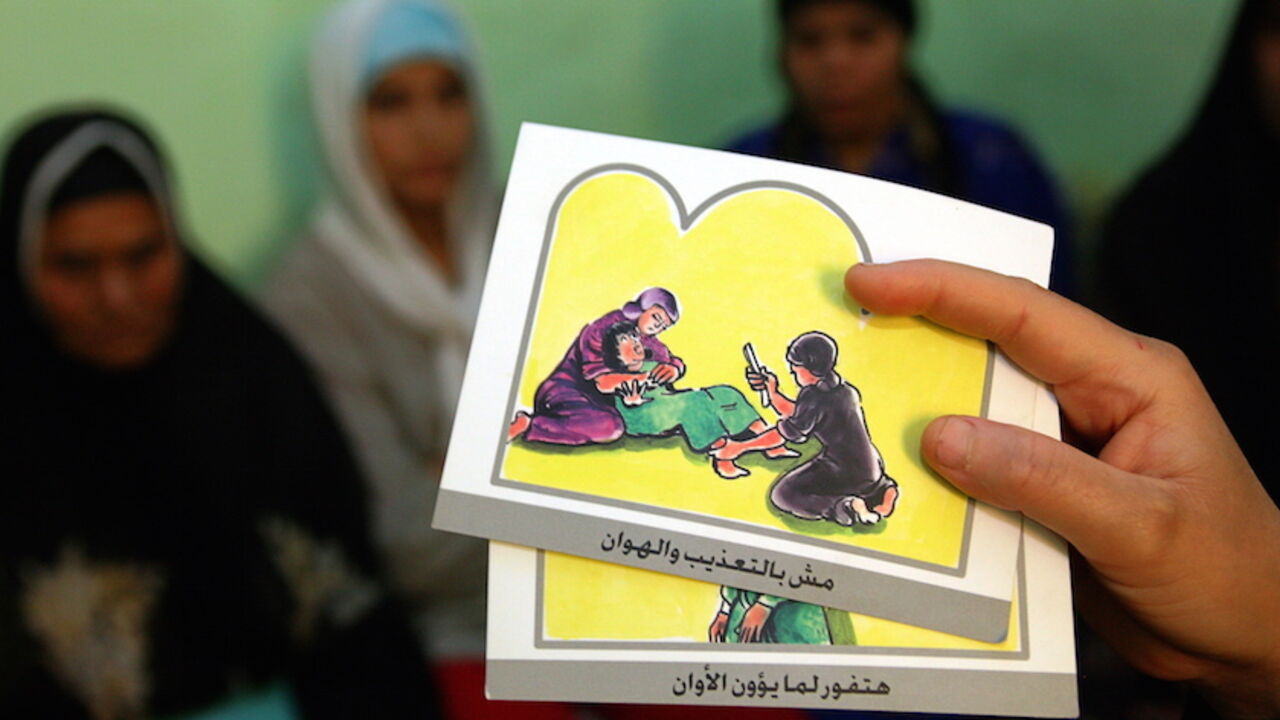 - PHOTO TAKEN 13JUN06 -
A counsellor holds up cards used to educate women about female genital mutilation (FGM) in Minia June 13, 2006. The practice of FGM dates back over two thousand years in Egypt and is widely practiced in all levels of society for [Muslims and Christians] alike. [Many organizations like UNICEF] have funded programs to help educate people about the risks and dangers of FGM in order to change people's opinions on this procedure which is seen by many as a necessary social norm. Picture ta