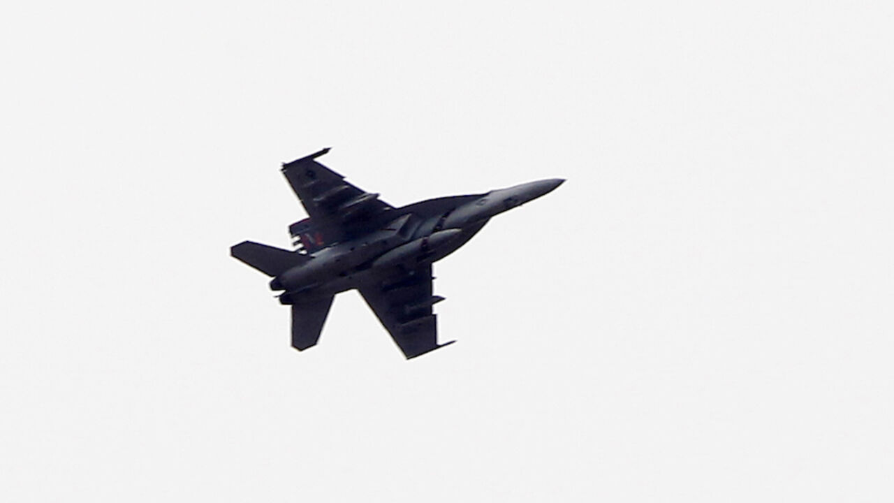 82266046 SANLIURFA, TURKEY - OCTOBER 19: (TURKEY OUT) A fighter jet flies above the Syrian town of Kobani on October 19, 2014 in Sanliurfa, Turkey. Kurdish fighters in Syrian city of Kobani have pushed back Islamic State militants in a number of locations as U.S. air strikes on ISIS positions continue in and around the city. In the past month more than 200,000 people from Kobani have fled into Turkey. (Photo by Gokhan Sahin/Getty Images)