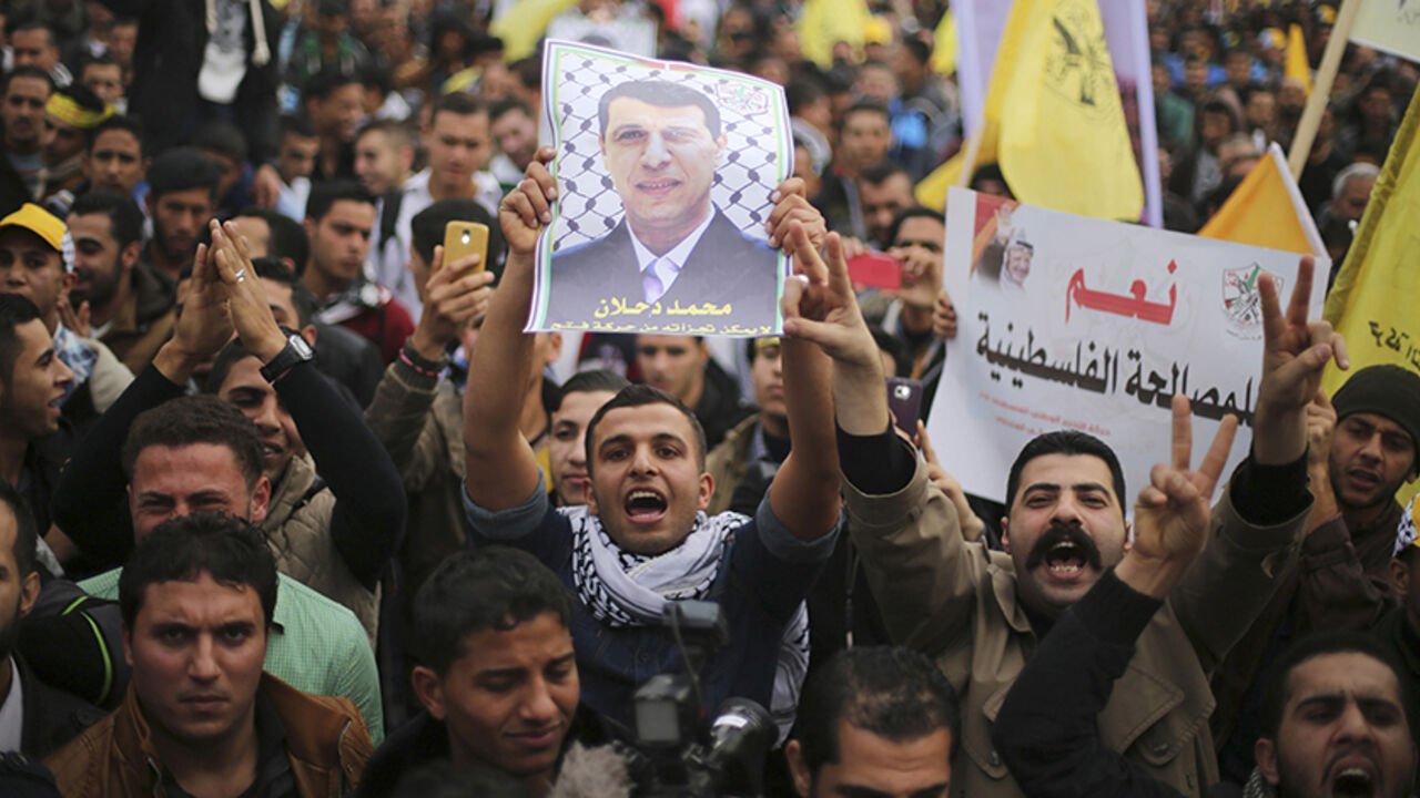 MIDEAST-PALESTINIANS/ A Palestinian supporter of former head of Fatah in Gaza, Mohammed Dahlan, holds a poster depicting Dahlan during a protest against Palestinian President Mahmoud Abbas in Gaza City December 18, 2014. Dahlan, who lives in exile in the Gulf, is a powerful political foe of Abbas.
REUTERS/Mohammed Salem (GAZA - Tags: POLITICS CIVIL UNREST) - RTR4IJ8R