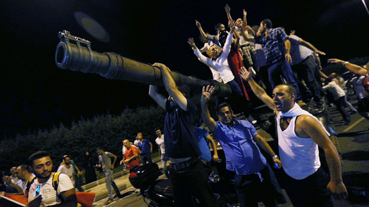 TURKEY-SECURITY/ People stand on a Turkish army tank at Ataturk airport in Istanbul, Turkey July 16, 2016. REUTERS/Huseyin Aldemir - RTSI871