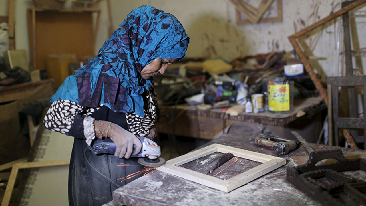 PALESTINIANS-DAILYLIFE/ Palestinian carpenter Amal Abu Regaiq, 43, works at her workshop in Nuseirat in the central Gaza Strip August 30, 2015. Abu Regaiq designs picture frames and sells them in the markets of the narrow enclave. REUTERS/Ibraheem Abu Mustafa - RTX1Q9CG