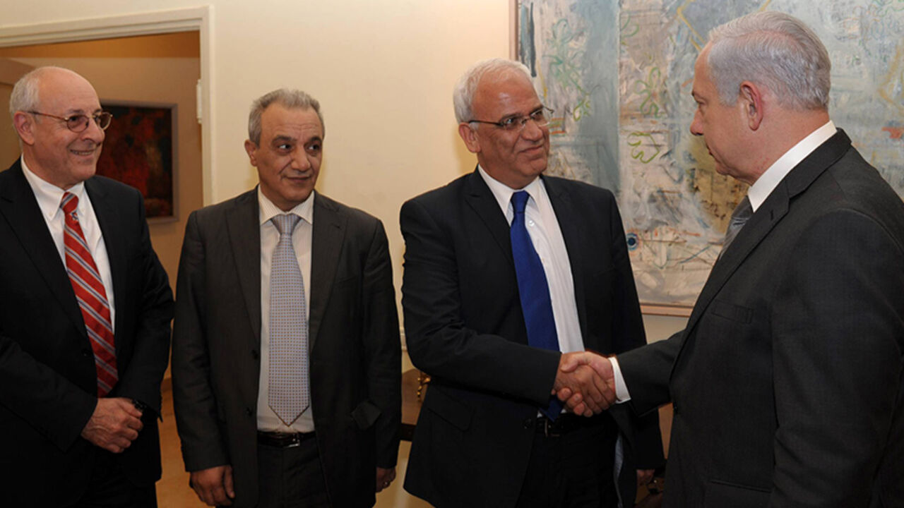69363689 JERUSALEM, ISRAEL - APRIL 17: In this handout image provided by the Israeli Government Press Office (GPO), Israel's Prime Minister Benjamin Netanyahu shakes hands with Palestinian chief negotiator Saeb Erekat watched by Netanyahu's personal envoy, attorney Yitzhak Molcho and the head of Palestinian Authority General Intelligence Majad Faraj during their meeting on April 17, 2012 in Jerusalem, Israel. At the end of the meeting, it was agreed to release the following statement: "Israel and the Palestinian Aut