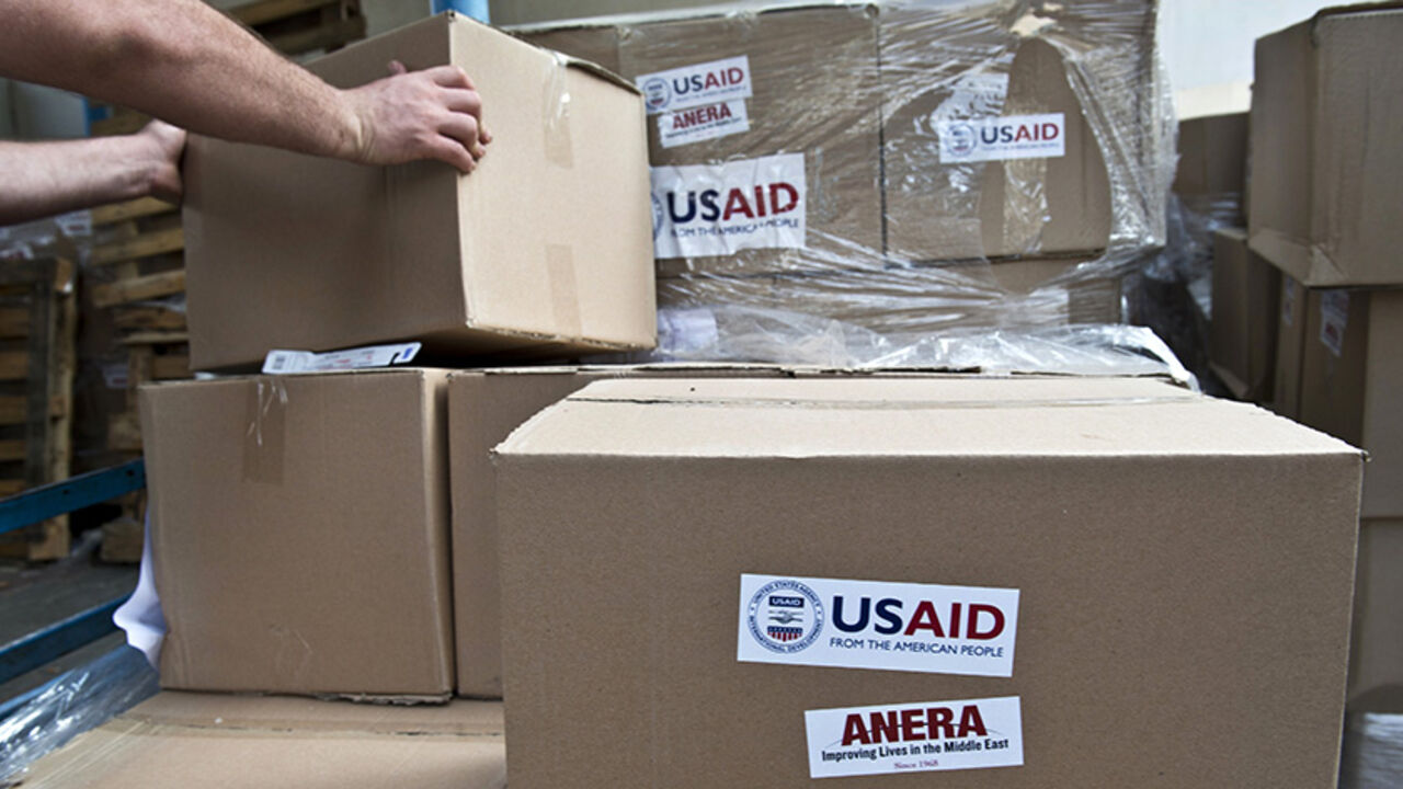Nic6361806 A UN worker takes a box containing sanitation kits and soap provided by the United States Agency for International Development (USAID) being stored at a UN school before a distribution to Palestinian displaced people on August 15, 2014 in Gaza City. The United Nations estimates that some 10,000 Palestinian homes were destroyed during fighting between Israel and Hamas during more than 4 weeks displacing hundreds of thousands from their homes in Gaza. A fragile ceasefire around Gaza held for a second day Frid