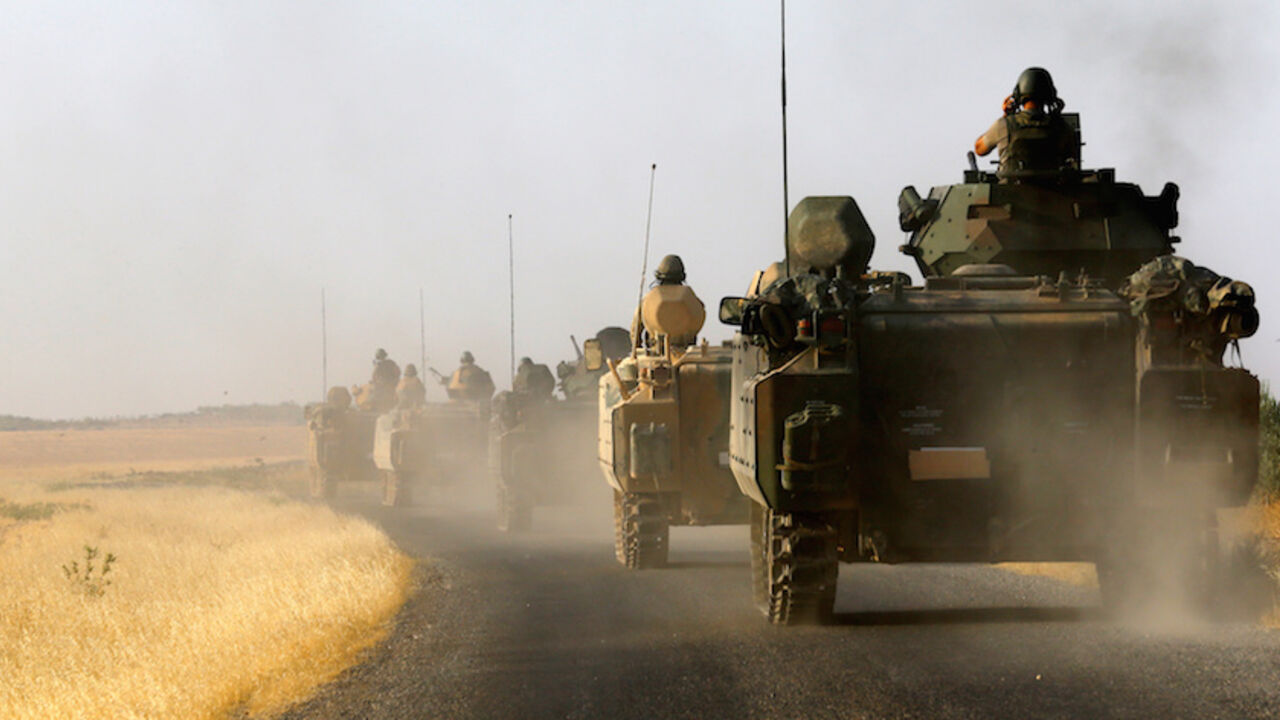 MIDEAST-CRISIS/IRAQ-TURKEY Turkish armoured personnel carriers drive towards the border in Karkamis on the Turkish-Syrian border in the southeastern Gaziantep province, Turkey, August 27, 2016. REUTERS/Umit Bektas/File Photo - RTSRWBD