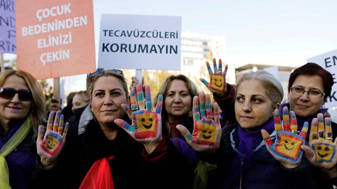 TURKEY-POLITICS/LAW Protesters show their painted hands during a protest against a proposal, that would have allowed sentencing in cases of sexual abuse committed "without force, threat or trick" before Nov. 16, 2016 to be indefinitely postponed if the perpetrator marries the victim, in front of the Turkish Parlaiment in Ankara, Turkey, November 22, 2016. Banners read, "Keep your hands off from a child's body" (L) and "Don't protect the rapists (R)" REUTERS/Umit Bektas - RTSSRKA