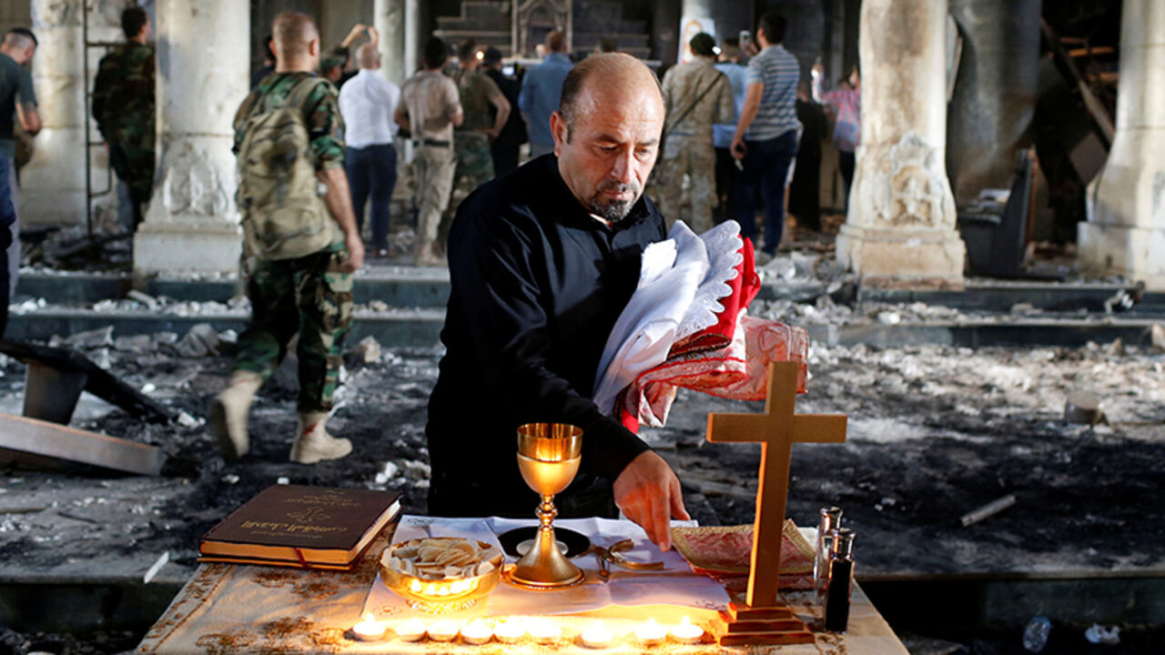 MIDEAST-CRISIS/IRAQ-MOSUL An Iraqi Christian prepares for the first Sunday mass at the Grand Immaculate Church since it was recaptured from Islamic State in Qaraqosh, near Mosul in Iraq October 30, 2016. REUTERS/Ahmed Jadallah TPX IMAGES OF THE DAY - RTX2R30Y