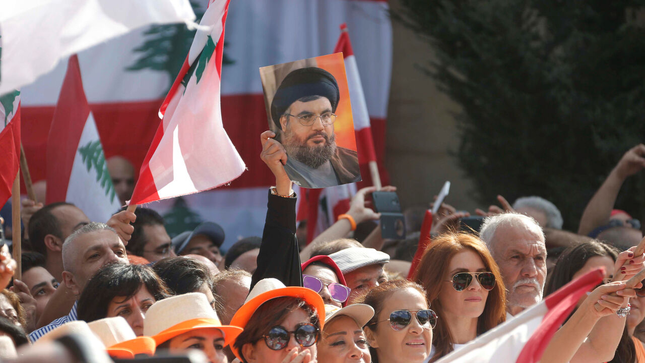LEBANON-PRESIDENCY/ A woman carries a picture of Hezbollah leader Hassan Nasrallah during an event to celebrate Lebanese President Michel Aoun's presidency, at the presidential palace in Baabda, near Beirut, Lebanon November 6, 2016. REUTERS/Mohamed Azakir - RTX2S4L6