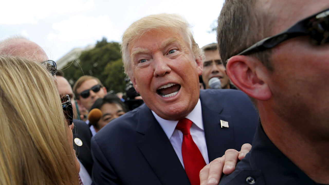USA-ELECTION/ U.S. Republican presidential candidate Donald Trump makes his way through the crowd after addressing a Tea Party rally against the Iran nuclear deal at the U.S. Capitol in Washington September 9, 2015. REUTERS/Jonathan Ernst/File Photo FROM THE FILES PACKAGE "THE CANDIDATES" - SEARCH CANDIDATES FILES FOR ALL 90 IMAGES - RTX2SFIW