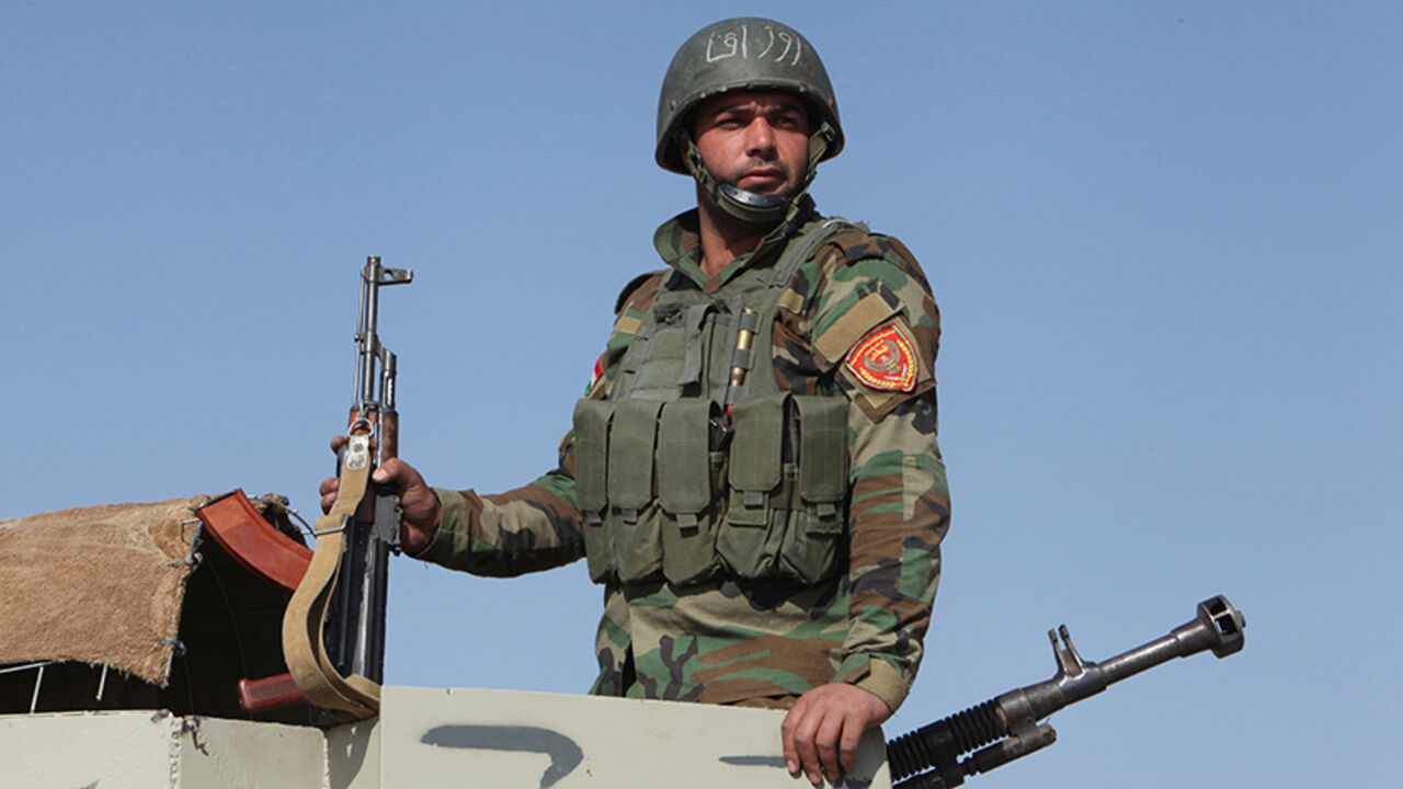 MIDEAST-CRISIS/MOSUL-SYRIANKURDS A Syrian Kurdish fighter rides in a military vehicle in the town of Bashiqa, after it was recaptured from the Islamic State, east of Mosul, Iraq, November 12, 2016. Picture taken November 12, 2016. REUTERS/Azad Lashkari - RTX2TLWW