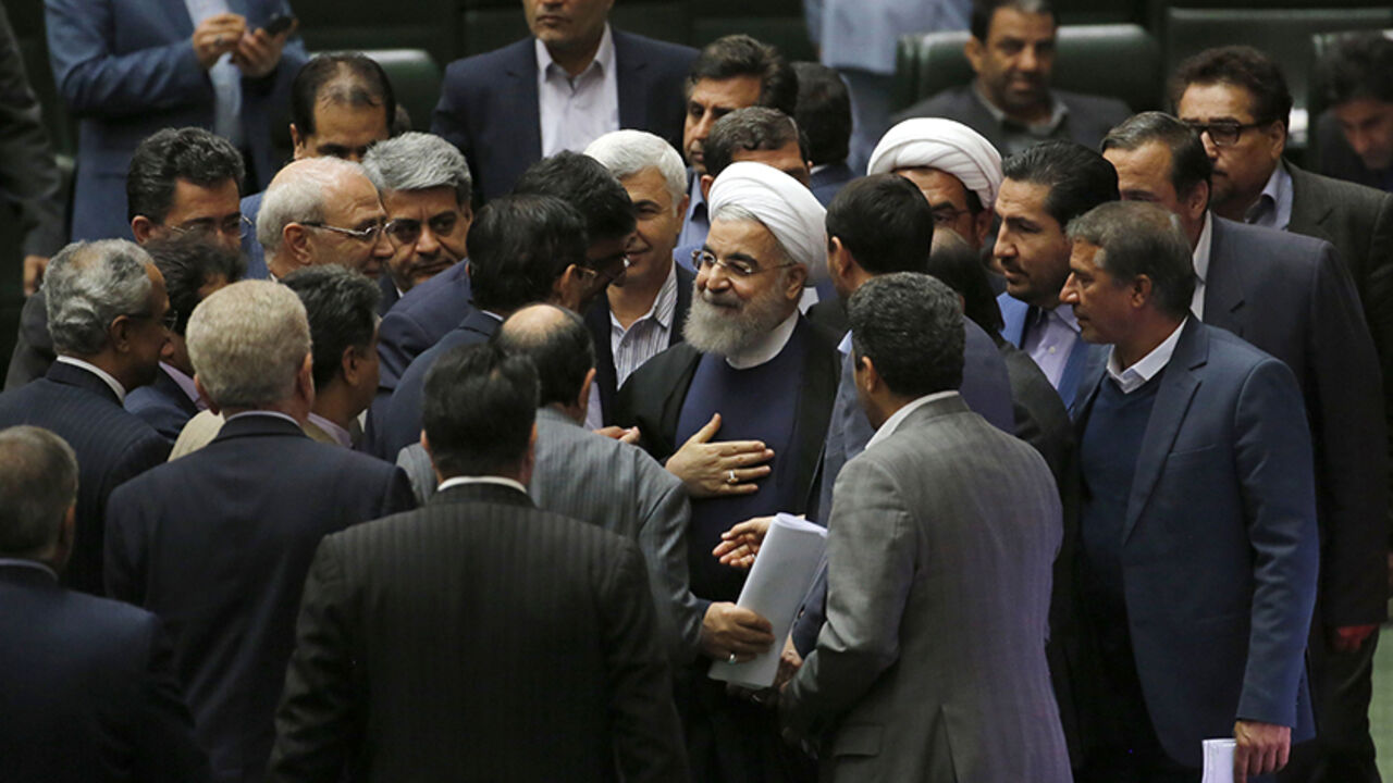 AFP_IQ69Y Iran's President Hassan Rouhani (C) speaks with MPs after presenting his budget for 2017-2018 to the parliament on December 4, 2016, in Tehran. / AFP / ATTA KENARE (Photo credit should read ATTA KENARE/AFP/Getty Images)
