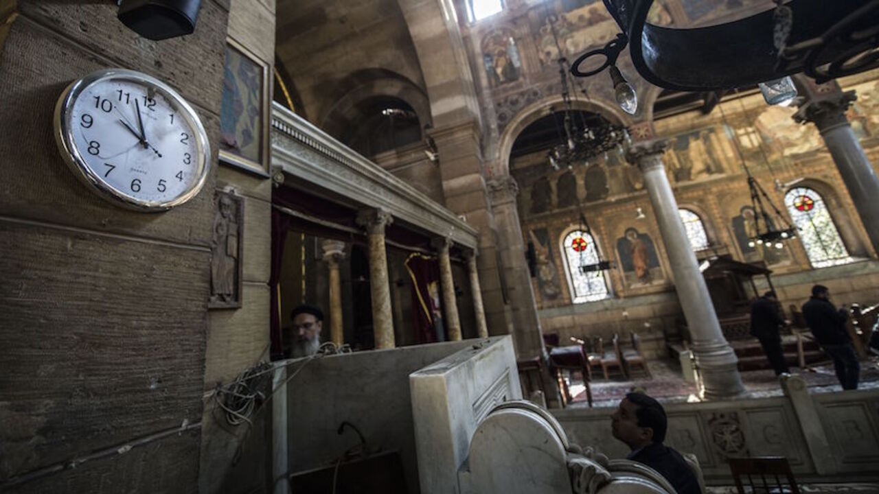 AFP_J02JZ Egyptian security forces and members of the clergy inspect the scene of a bomb explosion at the Saint Peter and Saint Paul Coptic Orthodox Church on December 11, 2016, in Cairo's Abbasiya neighbourhood.
The blast killed at least 25 worshippers during Sunday mass inside the Cairo church near the seat of the Coptic pope who heads Egypt's Christian minority, state media said. / AFP / KHALED DESOUKI (Photo credit should read KHALED DESOUKI/AFP/Getty Images)