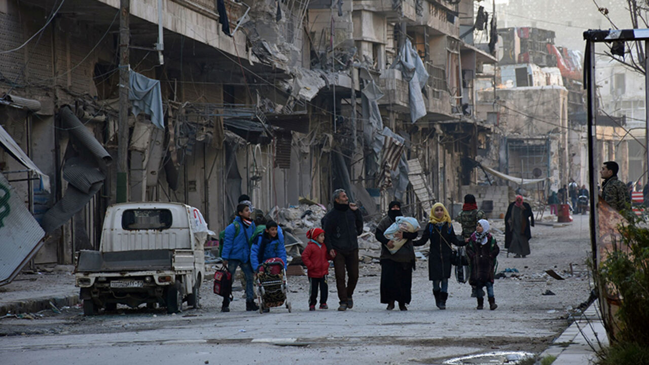 MIDEAST-CRISIS/SYRIA-ALEPPO People, who evacuated the eastern districts of Aleppo, carry their belongings as they arrive in a government held area of Aleppo, Syria, in this handout picture provided by SANA on December 7, 2016. SANA/Handout via REUTERS ATTENTION EDITORS - THIS PICTURE WAS PROVIDED BY A THIRD PARTY. REUTERS IS UNABLE TO INDEPENDENTLY VERIFY THE AUTHENTICITY, CONTENT, LOCATION OR DATE OF THIS IMAGE. FOR EDITORIAL USE ONLY. - RTSV3U9