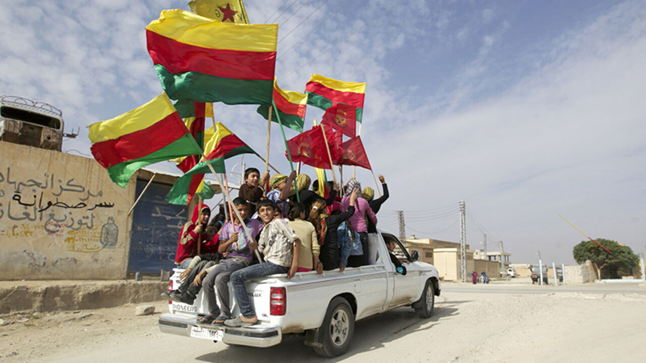 SYRIA-CRISIS/KURDS People sit in the back of a truck as they celebrate what they said was the liberation of villages from Islamist rebels near the city of Ras al-Ain in the province of Hasakah, after capturing it from Islamist rebels November 6, 2013. Redur Xelil, spokesman for the armed wing of the Syrian Kurdish Democratic Union Party (PYD), said Kurdish militias had seized the city of Ras al-Ain and all its surrounding villages. Syrian Kurdish fighters have captured more territory from Islamist rebels in northeastern Syria