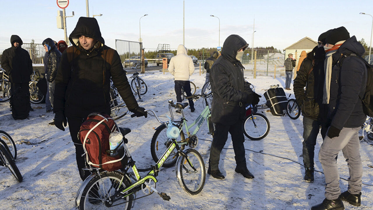 EUROPE-MIGRANTS/RUSSIA-NORWAY Refugees and migrants gather near a check point on the Russian-Norwegian border outside Nickel (Nikel) settlement in Murmansk region, Russia, October 30, 2015. The flow of Middle Eastern migrants trying to reach Europe via the Russian Arctic slowed dramatically on October 29, partly due to a shortage of bicycles to cross the border, a source who deals with them told Reuters. According to officials, many Syrians obtain business or study visas to enter Russia and then travel through Moscow and Murmansk to Nic