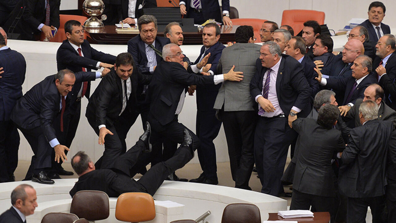 Par8103017 Lawmakers from the main opposition Republican People's Party (CHP) and ruling AK Party (R) scuffle during a debate on a legislation to boost police powers, at the Turkish Parliament in Ankara late February 19, 2015 AFP PHOTO/ADEM ALTAN (Photo credit should read ADEM ALTAN/AFP/Getty Images)