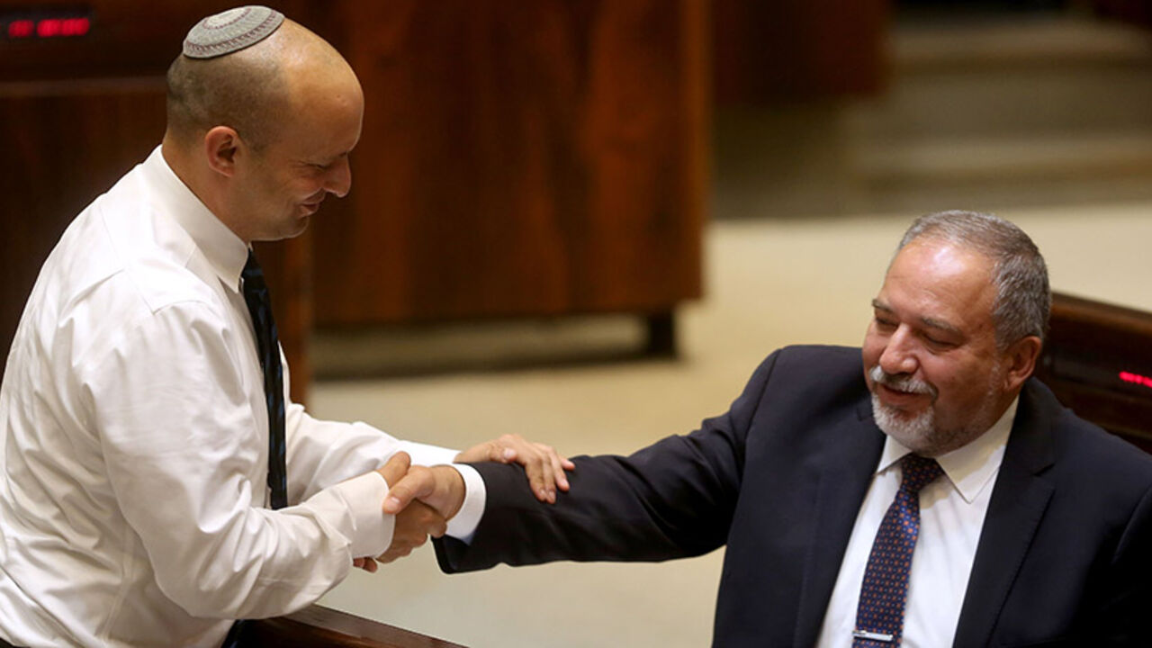 AFP_BC97R Israeli Jewish Home party leader Naftali Bennett (L) greets former Israeli foreign minister and ultra-nationalist MP Avigdor Lieberman during a session of the Israeli parliament in which MPs are debating whether to approve Lieberman's appointment as defence minister, on May 30, 2016 in Jerusalem.
Israeli Prime Minister Benjamin Netanyahu's cabinet voted to expand his coalition and appoint hardliner Avigdor Lieberman as defence minister, bringing weeks of political intrigue -- and outrage -- towards a close.