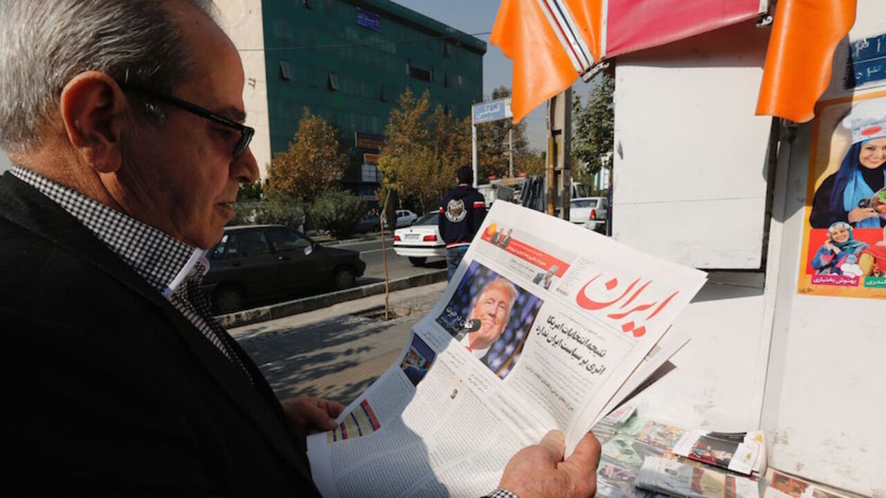 AFP_HY9YD An Iranian man holds a local newspaper displaying a portrait of Donald Trump a day after his election as the new US president, in the capital Tehran, on November 10, 2016.
Iran's President Hassan Rouhani said on November 9 there was "no possibility" of its nuclear deal with world powers being overturned by US president-elect Donald Trump despite his threat to rip it up.
/ AFP / ATTA KENARE (Photo credit should read ATTA KENARE/AFP/Getty Images)
