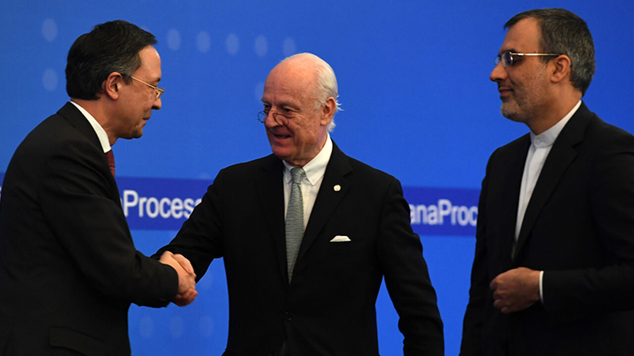 AFP_KN00M UN Syria envoy Staffan de Mistura (C) shakes hands with Kazakh Foreign Minister Kairat Abdrakhmanov (L) as Iran's Deputy Foreign Minister Hossein Jaber Ansari stands beside during the announcement of a final statement following Syria peace talks in Astana on January 24, 2017. / AFP / Kirill KUDRYAVTSEV (Photo credit should read KIRILL KUDRYAVTSEV/AFP/Getty Images)