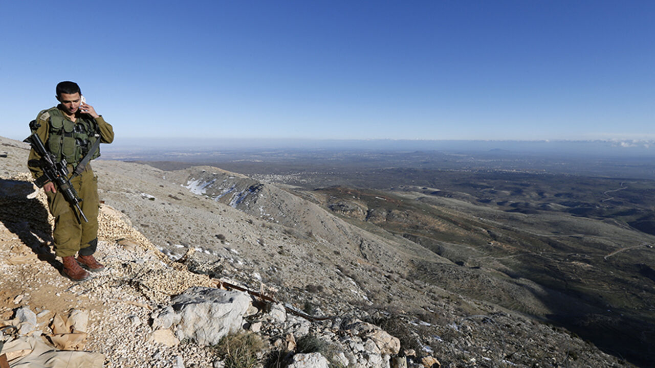 ISRAEL-NETANYAHU/ An Israeli soldier speaks on his mobile phone at a military outpost on Mount Hermon in the Golan Heights over looking the Israel-Syria border February 4, 2015. REUTERS/Baz Ratner (ISRAEL - Tags: POLITICS CIVIL UNREST CONFLICT) - RTR4O8R8