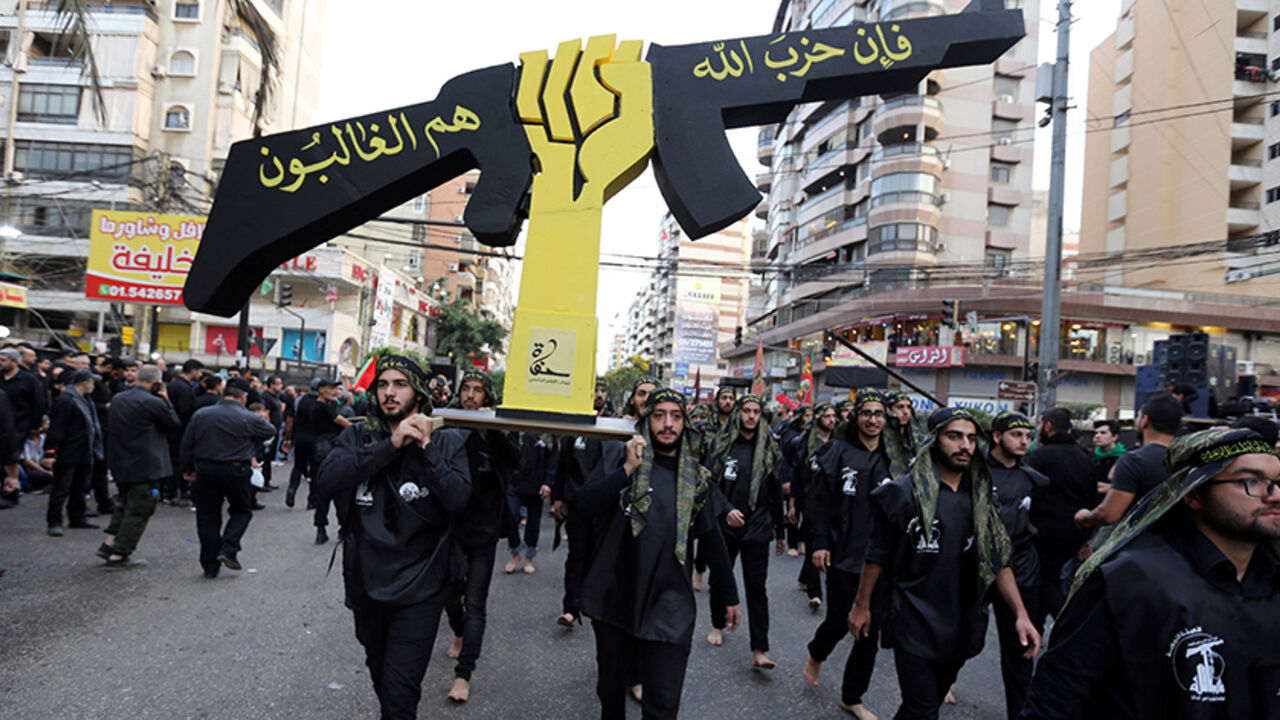 MIDEAST-CRISIS/LEBANON-ASHURA Lebanese Hezbollah supporters carry a replica of Hezbollah emblem during a religious procession to mark Ashura in Beirut's southern suburbs, Lebanon October 12, 2016. REUTERS/Aziz Taher - RTSRWQ6