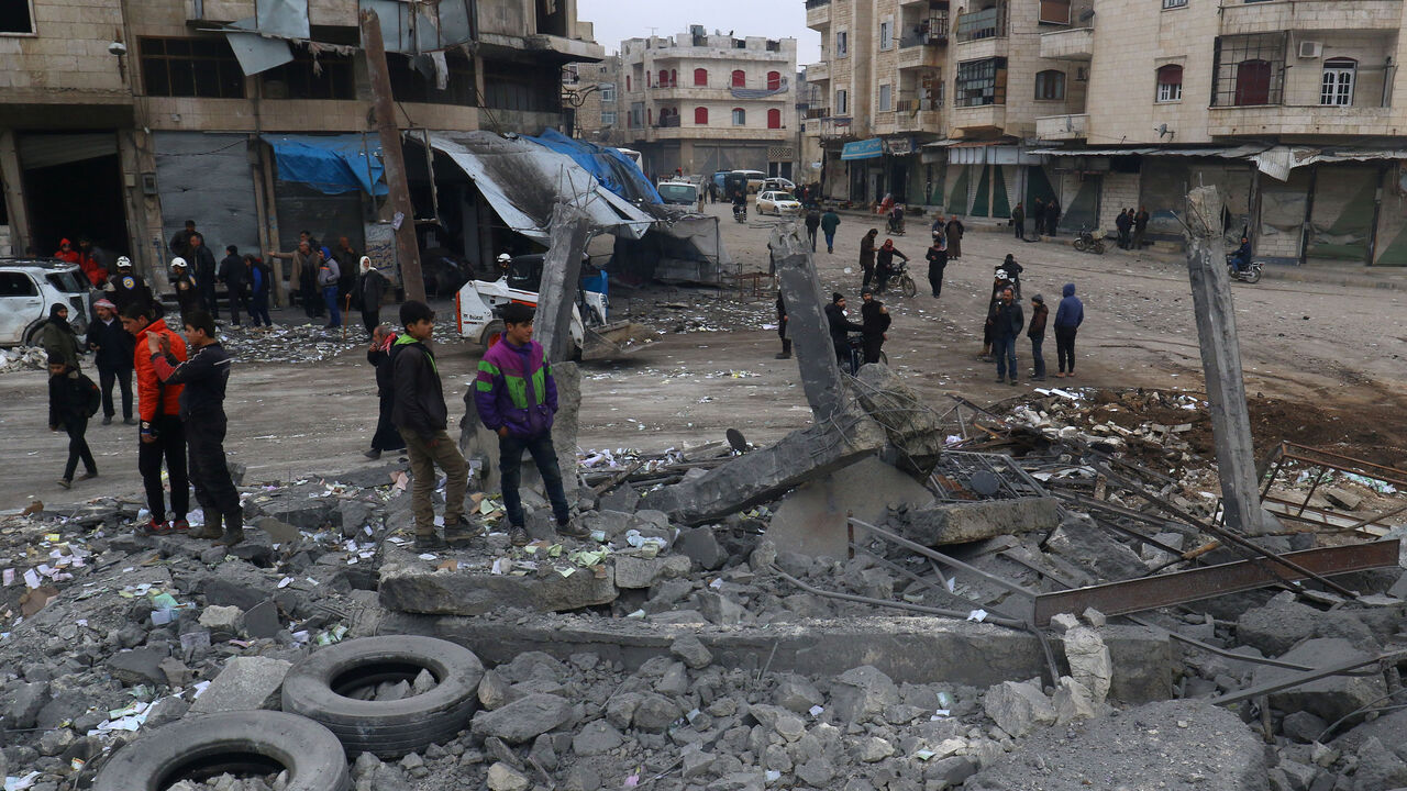 People inspect a site hit by airstrikes at a parking garage in the rebel-held city of Idlib, Syria January 18, 2017. REUTERS/Ammar Abdullah - RTSW2U6
