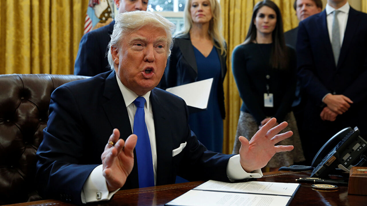 USA-TRUMP/ U.S. President Donald Trump speaks to reporters while signing executive orders at the White House in Washington January 24, 2017. REUTERS/Kevin Lamarque - RTSX5NX