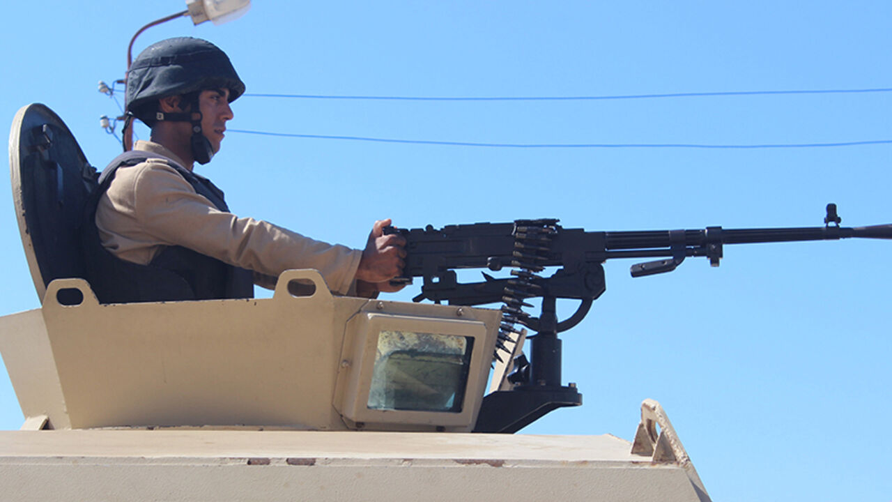 EGYPT-CRASH/INSURGENCY-INSIGHT An Egyptian army soldier looks on from his postion at a checkpoint in Al Arish city, in the troubled northern part of the Sinai peninsula, July 8, 2015. Giant posters of Egyptian President Abdel Fattah al-Sisi in military uniform hang at security checkpoints leading to the Sinai, but the crash of a Russian airliner in the peninsula has shattered the image of control they seek to project. Picture taken July 8, 2015. To match EGYPT-CRASH/INSURGENCY-INSIGHT REUTERS/Stringer - RTX1V321