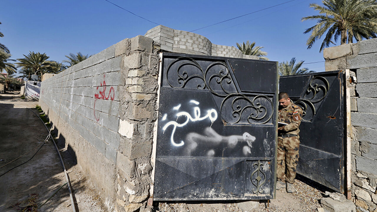 MIDEAST-CRISIS/IRAQ-RAMADI Graffiti warning on a house saying that the house is mined is seen in the city of Ramadi, January 16, 2016. Baghdad and Washington have touted Ramadi as the first major success for Iraq's U.S.-backed army since it collapsed in the face of Islamic State's lightning advance across the country's north and west in mid-2014. But the scorched-earth battlefield tactics used by both sides mean the prize is a shattered ruin. Picture taken January 16, 2016. REUTERS/Thaier Al-Sudani - RTX22WLQ